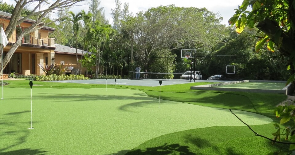 a backyard recreation area including bocce court, putting green, and a multi-sport game court