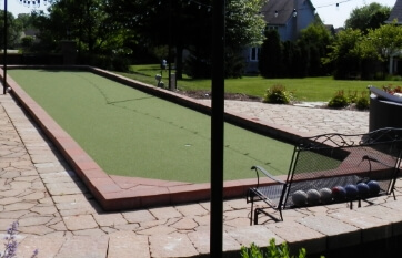 landscape wall block and paver stones used as a decorative border for a bocce court