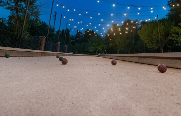 a loose fill bocce court at night