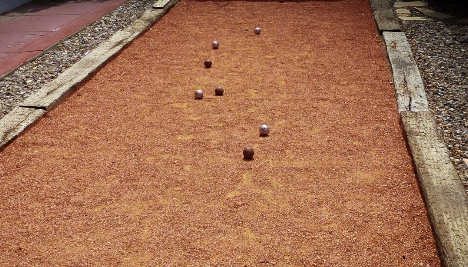 a red clay surfaced bocce court