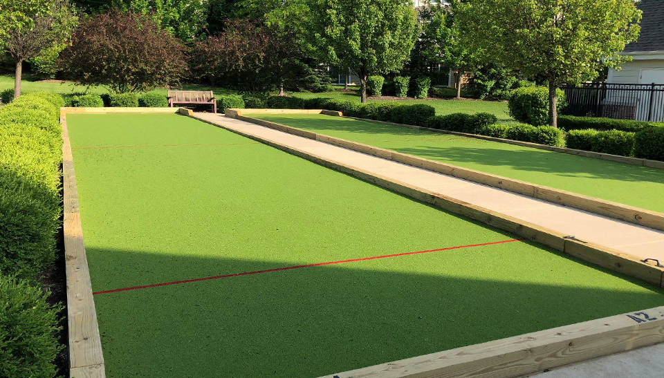 Double Synthetic Turf Bocce Courts Surrounded by Concrete