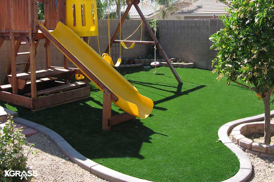 Synthetic turf installed underneath backyard playground set