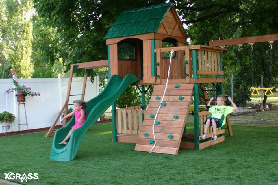 Backyard playground installed with artificial grass