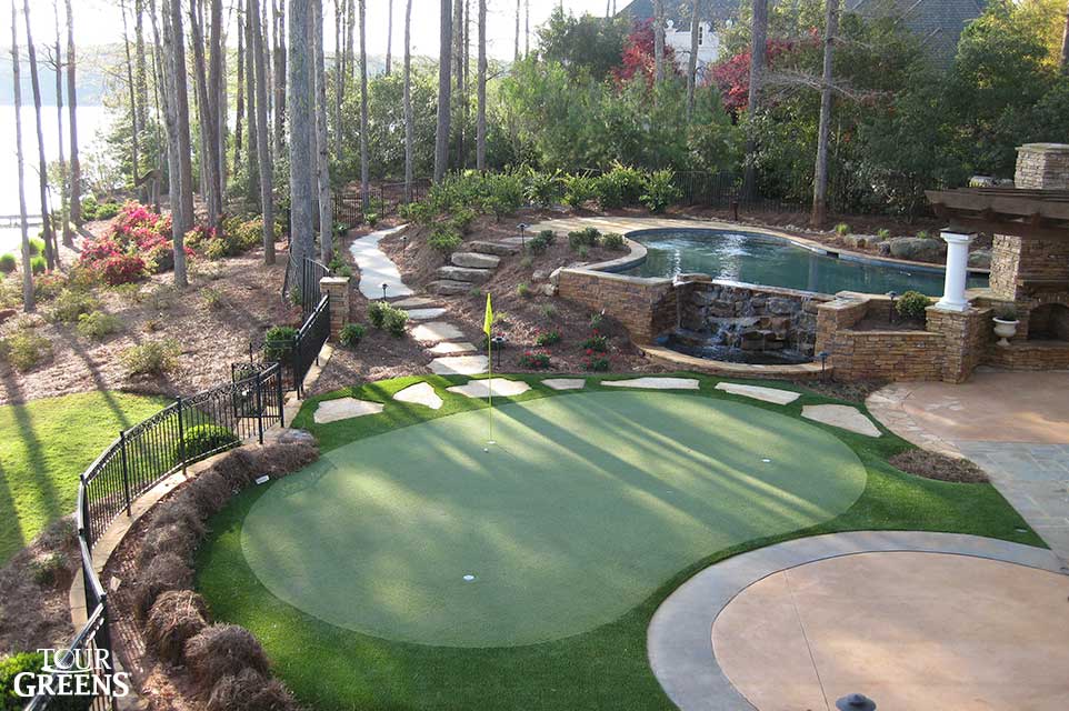 Poolside putting green installed at a lakefront home