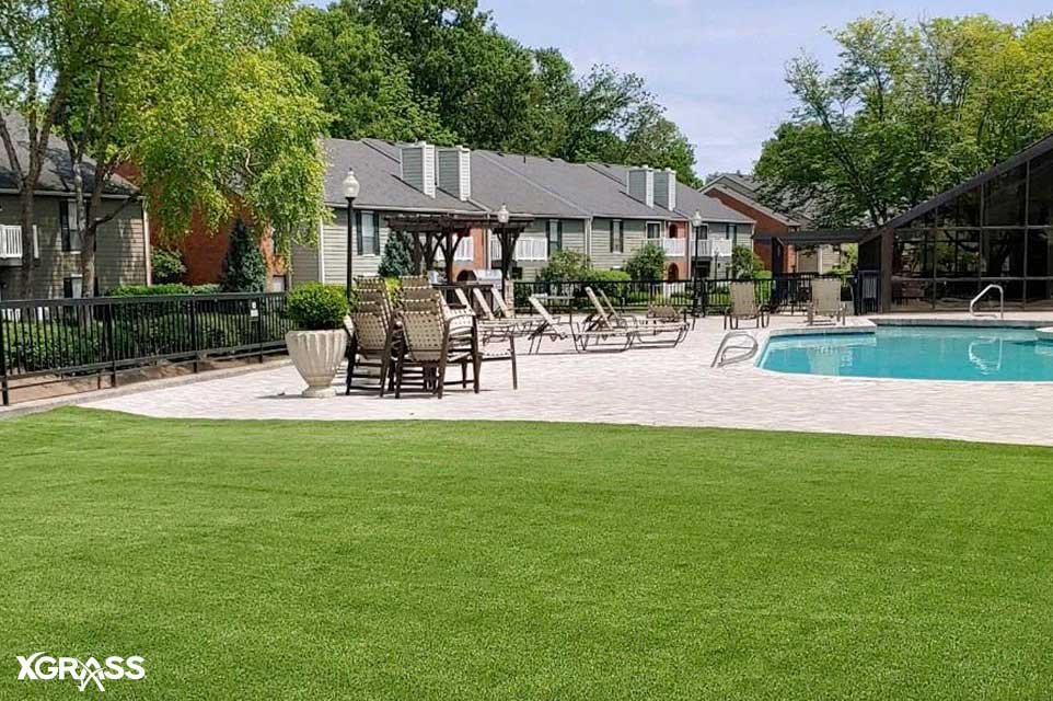 Apartment complex pool with artificial grass installed next to it