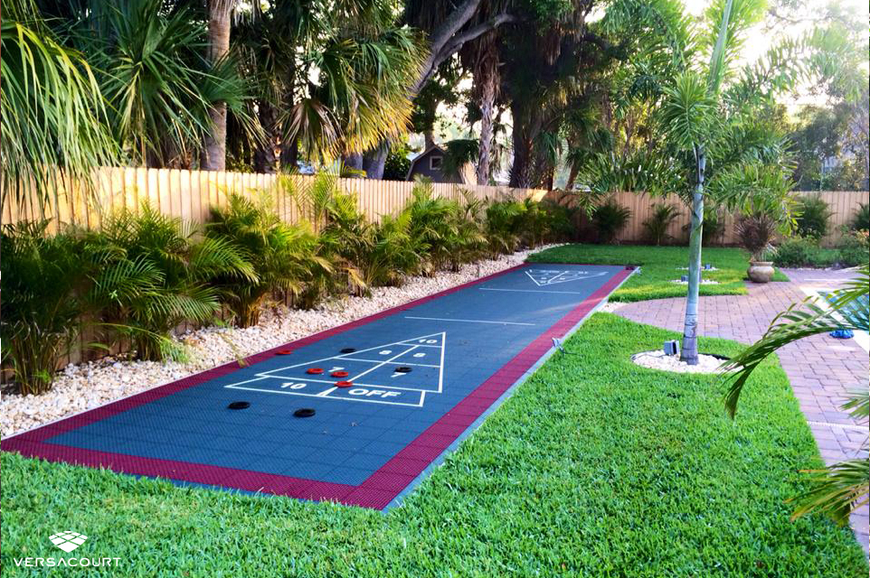Shuffleboard court installed in a small tropical backyard area