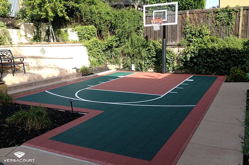 Small backyard with a VersaCourt half-court basketball court installed